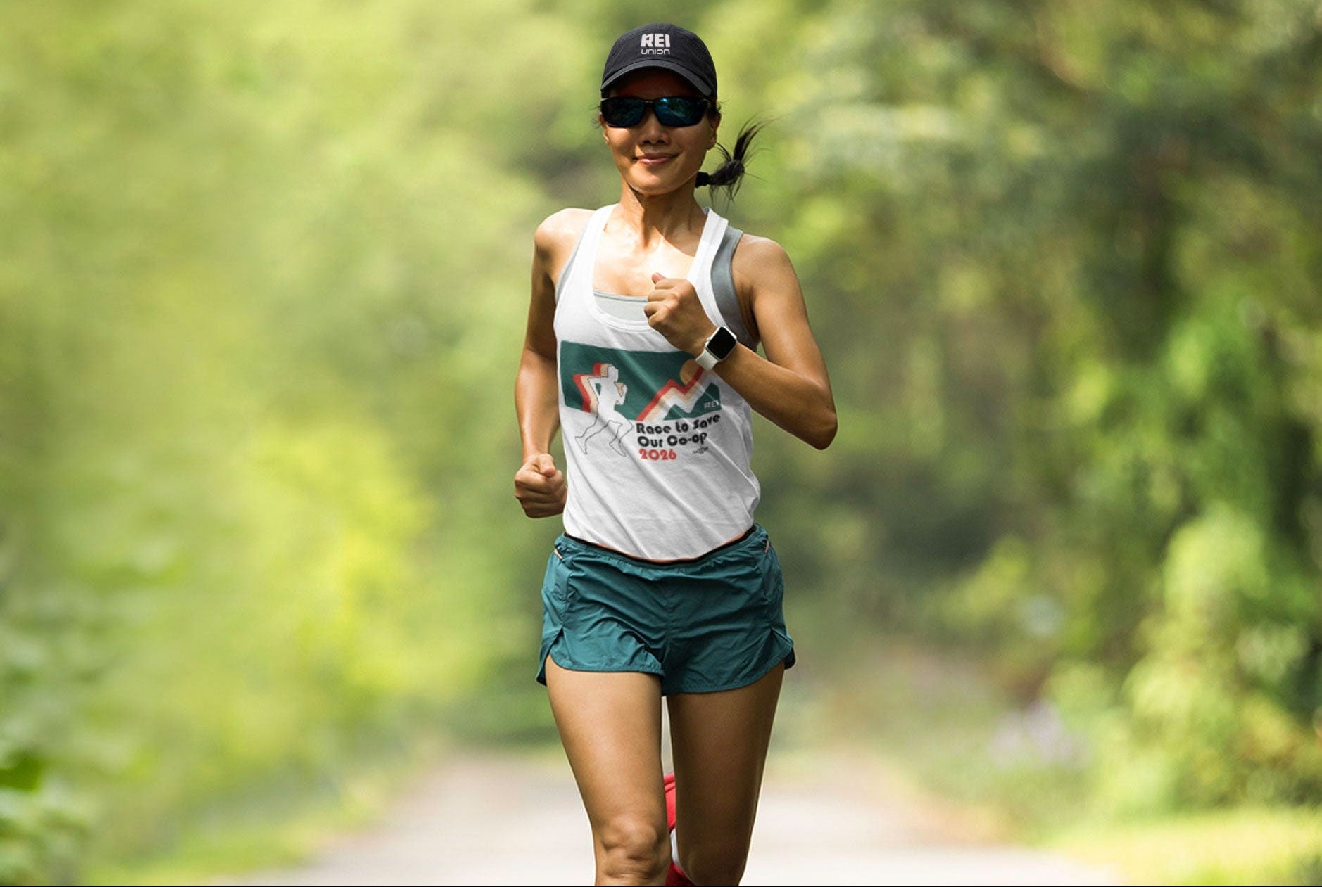 Woman running on a path with greenery in the background